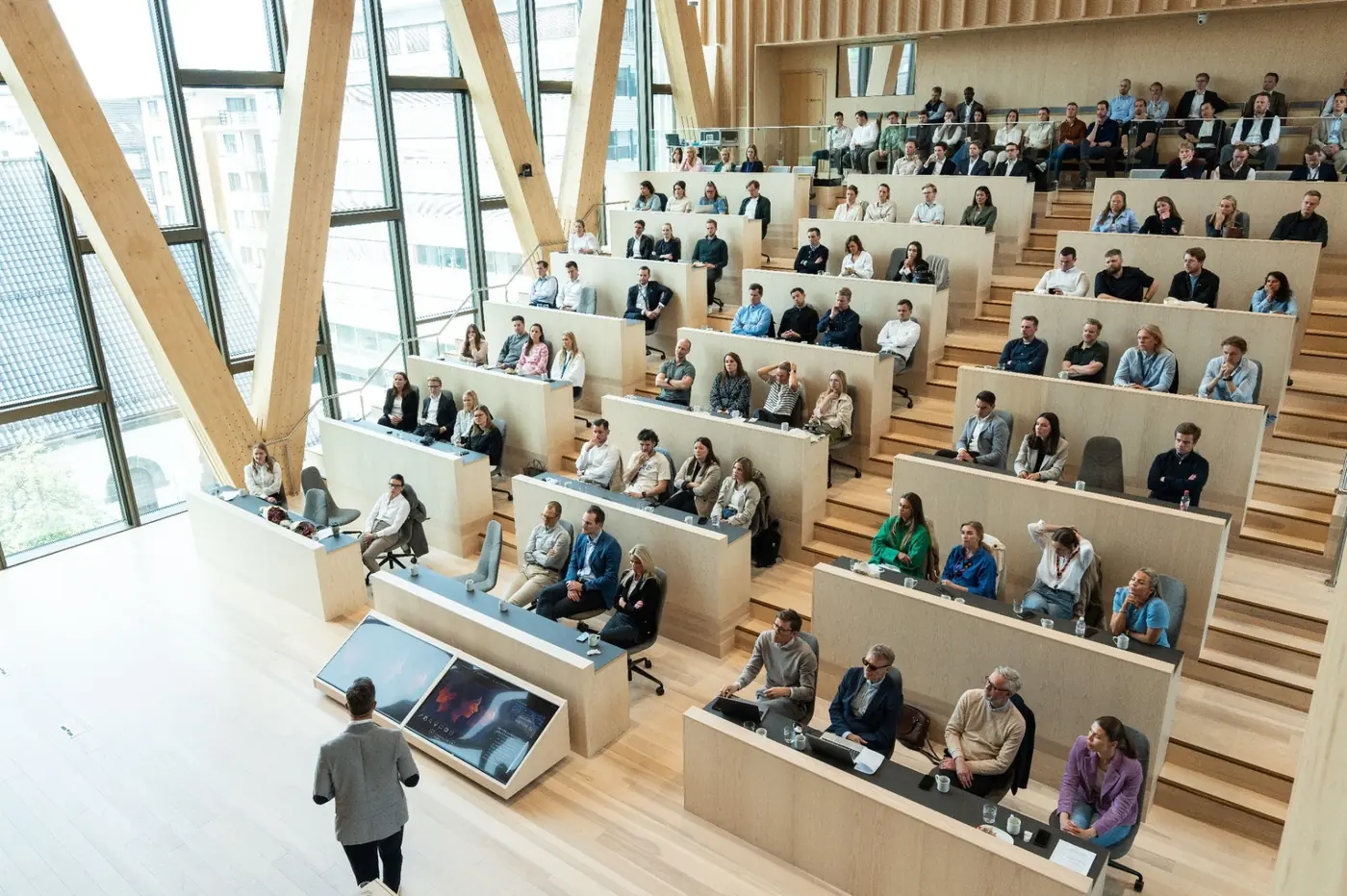 Publikum på UEV-konferansen i auditorium med trearkitektur